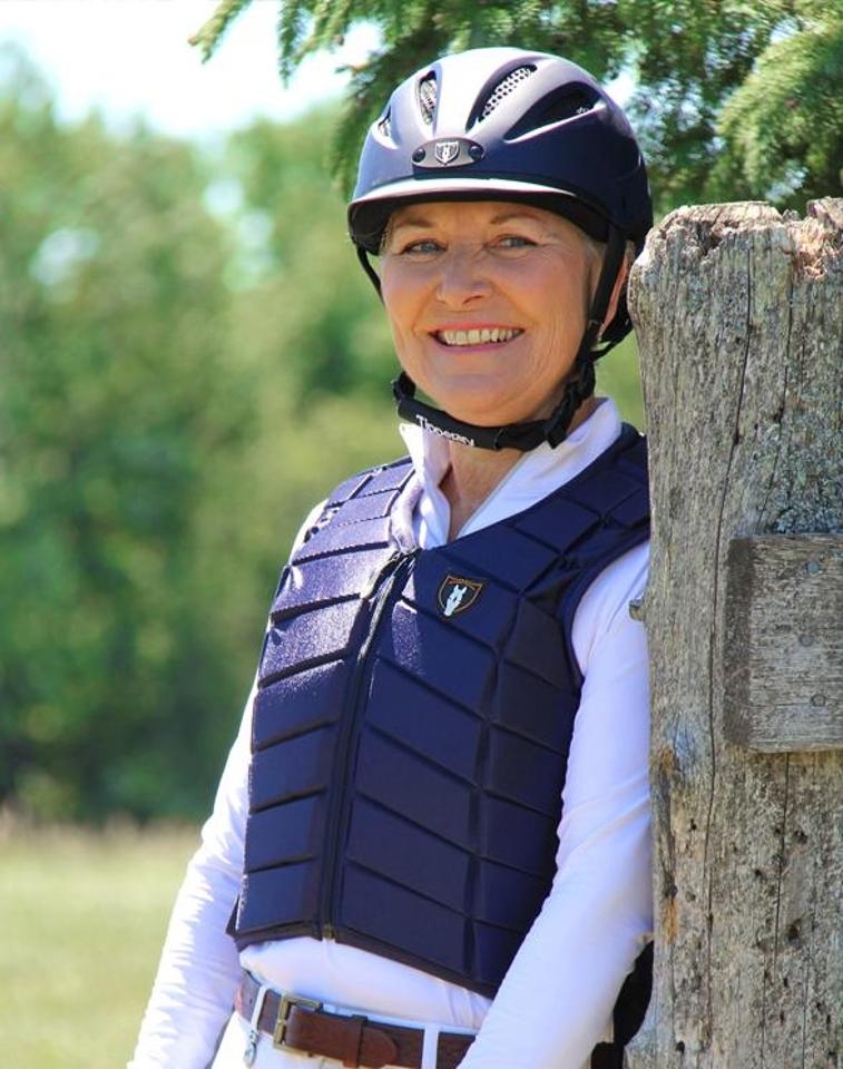 Navy equestrian body protector with a sleek design and adjustable straps.