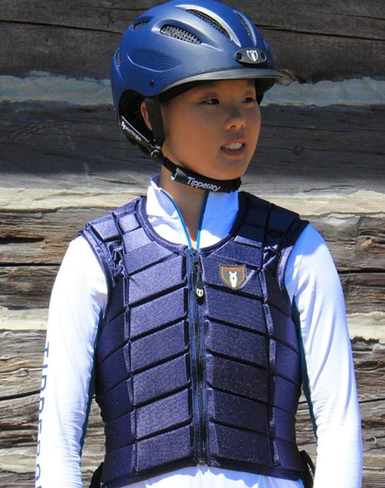 Navy equestrian body protector vest with zip closure and logo, worn with a blue riding helmet.