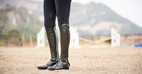 Black leather riding boots with a sleek design, ideal for equestrian wear.