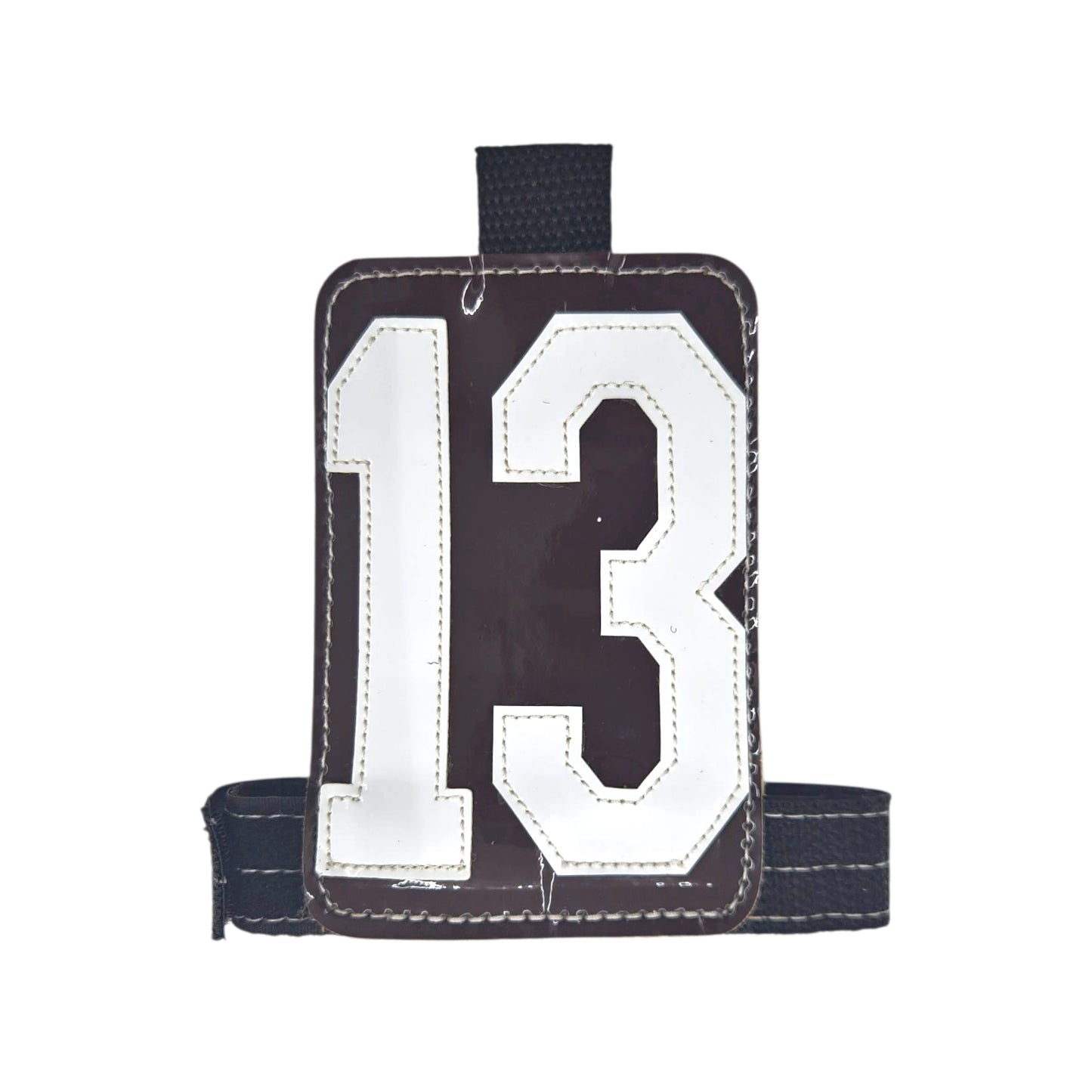 Brown luggage tag with white number 13, featuring a sturdy black strap.