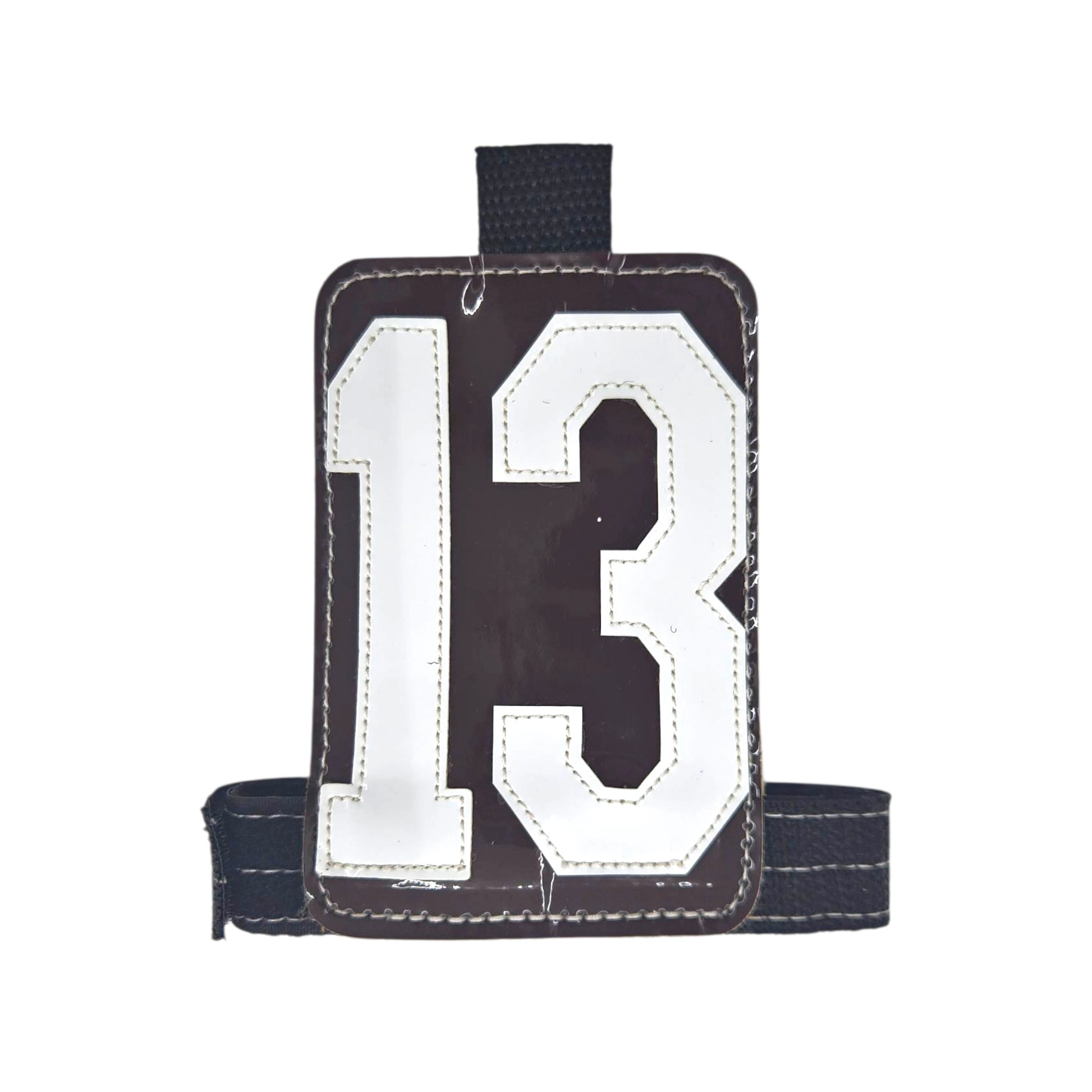 Brown luggage tag with white number 13, featuring a sturdy black strap.