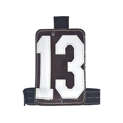 Brown luggage tag with white number 13, featuring a sturdy black strap.