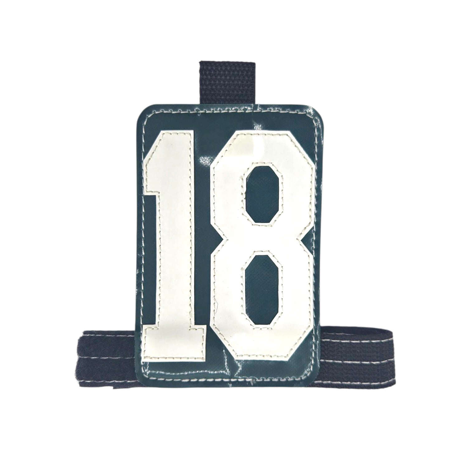 Green sports bib featuring the number 18 with a black adjustable strap.