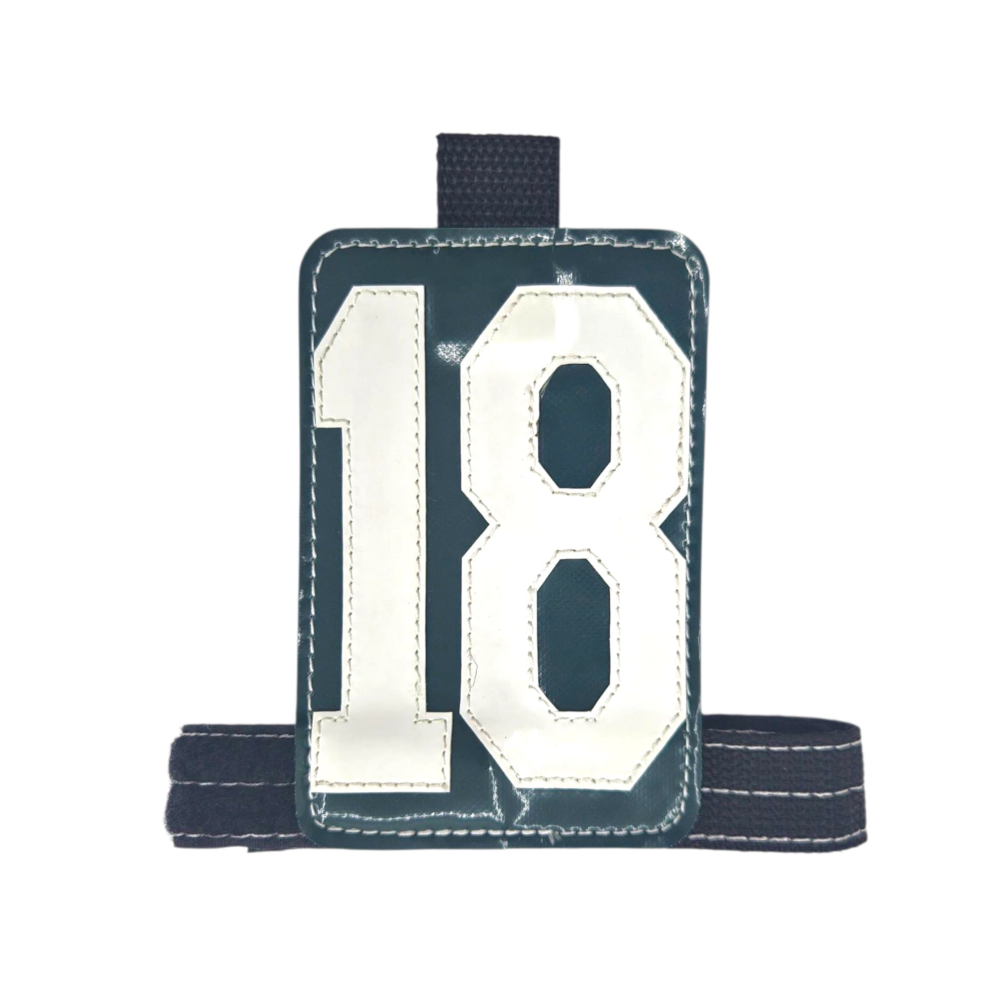 Green sports bib featuring the number 18 with a black adjustable strap.