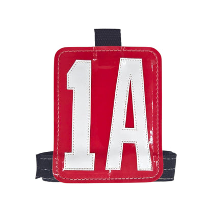 Red number tag with white '1A' lettering and black straps for secure attachment.