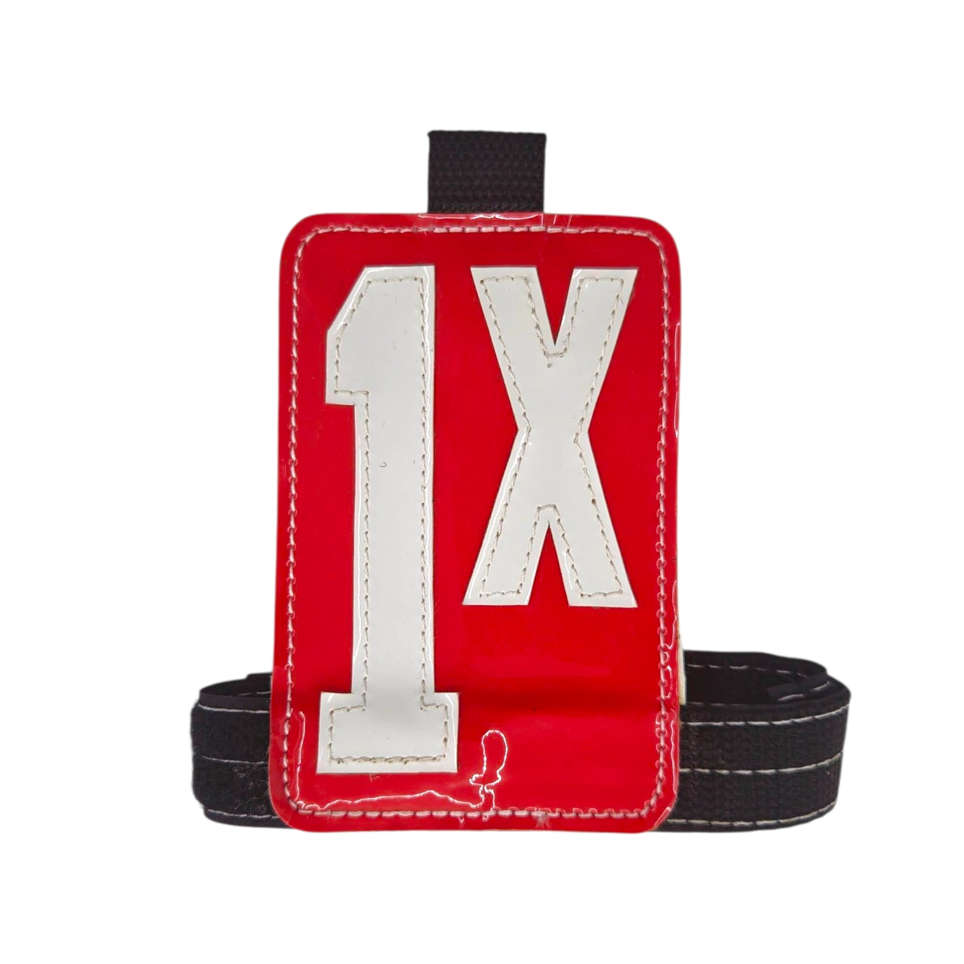 Red fabric tag holder with white number "1X" and black strap.